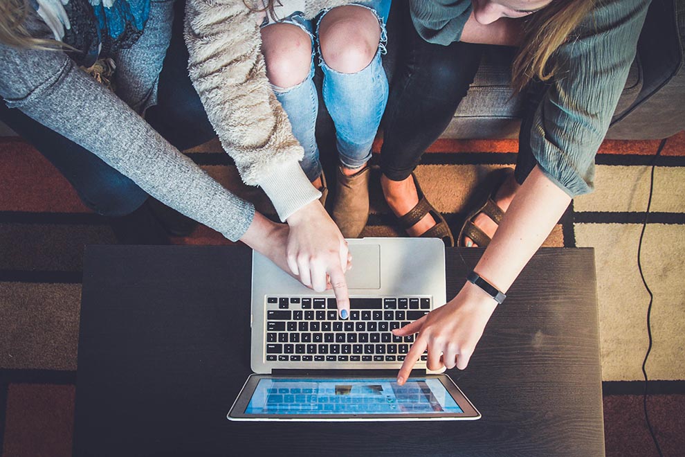 An image of students looking at a  computer