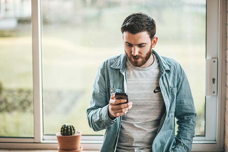 An image of students with a phone